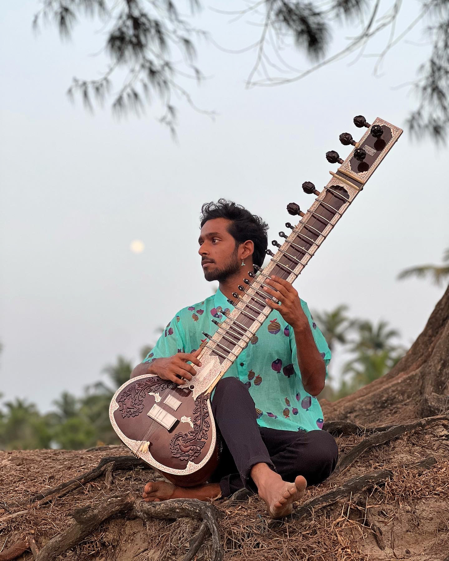 Vrujen with a sitar outdoors